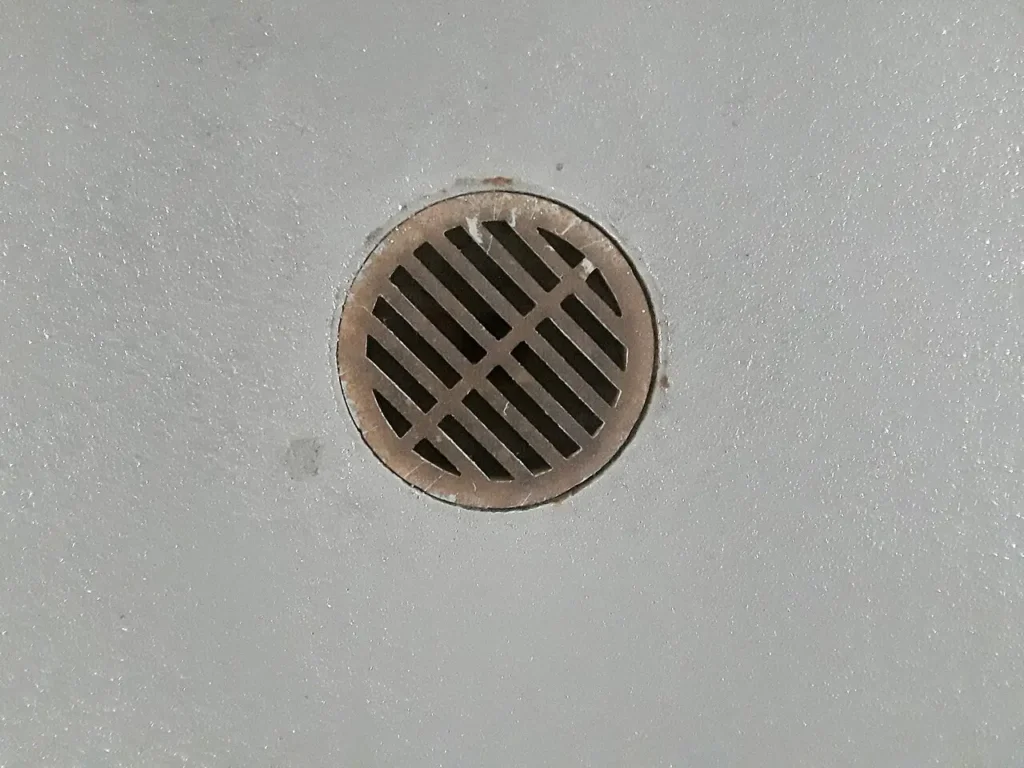 Round metal floor drain set in a concrete floor