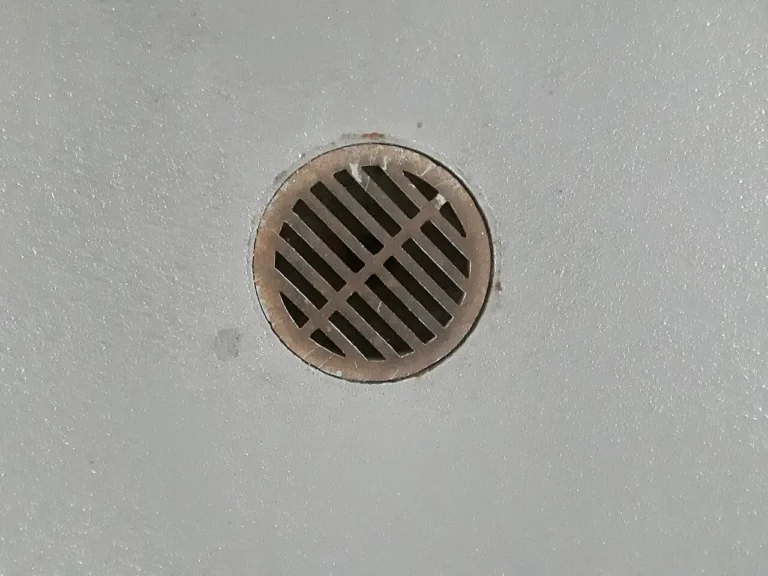 Round metal floor drain set in a concrete floor